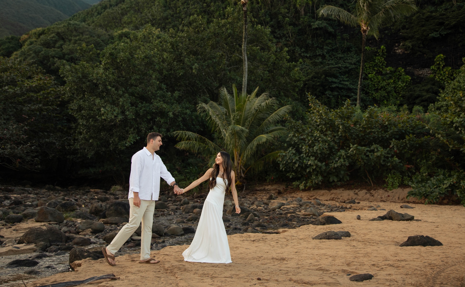 Couple on a Kauaʻi beach with palms